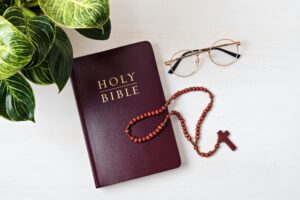 Holy Bible on white wooden table. Christian devotion, Easter celebration